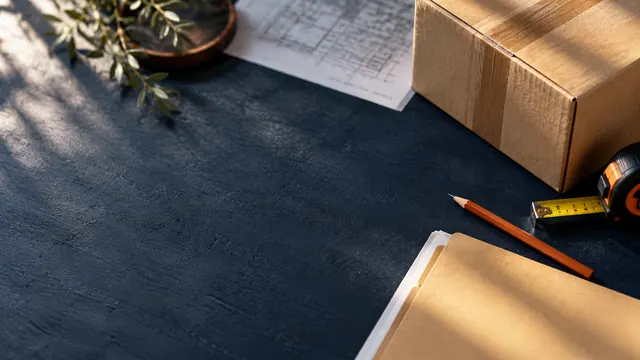 Shipping box, measuring tape and document folder on a desk